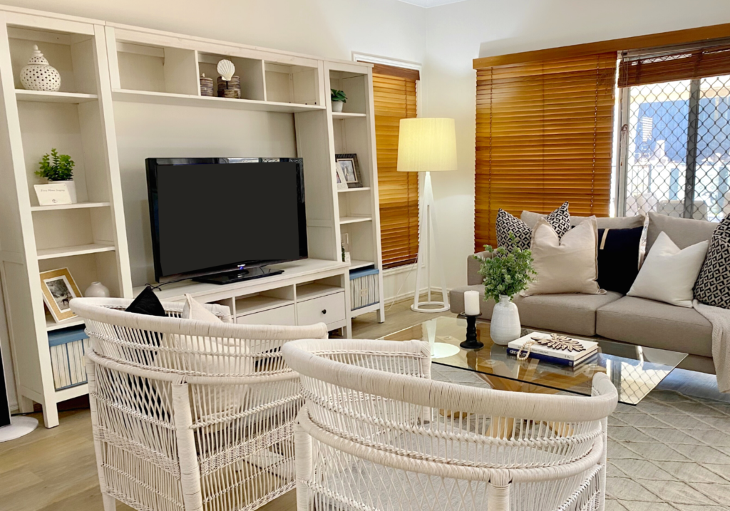 coastal style interior design living room with a TV and a shelf