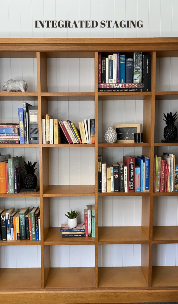 a bookshelf portraying integrated staging - old books, clients decorations in combination with some of our decorations