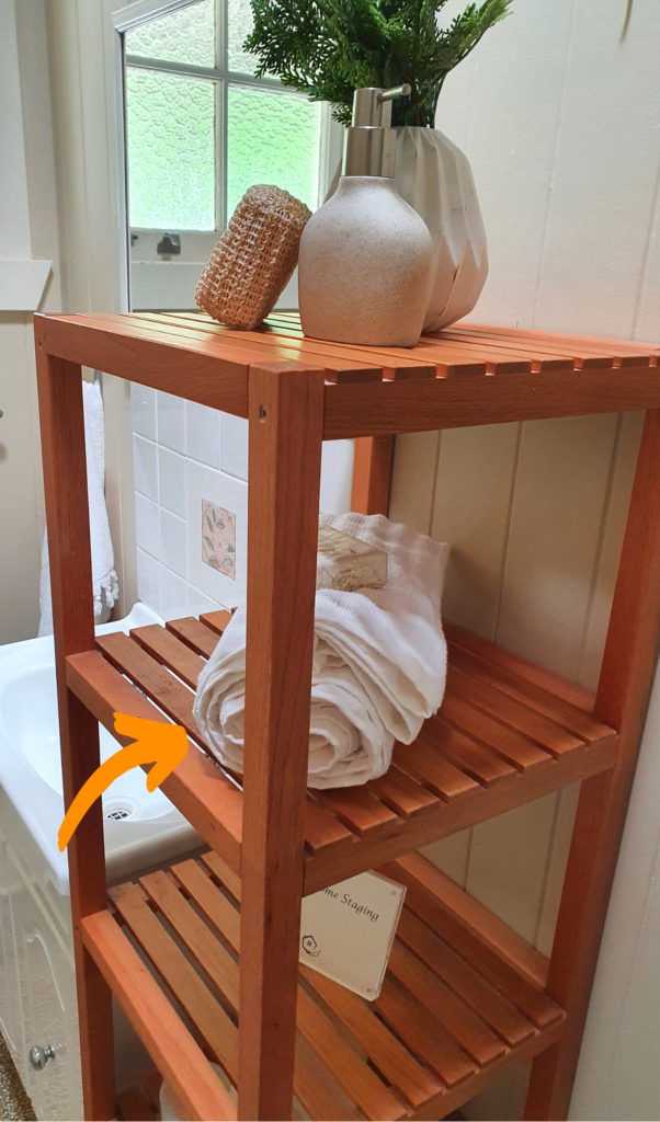 wooden shelves with a rolled up white towel