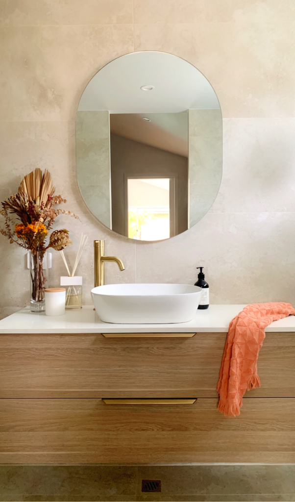 beautiful bathroom with an orange towel draped over the vanity