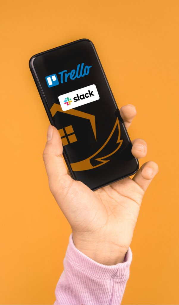 person holding up a phone with the logos of Trello & Slack