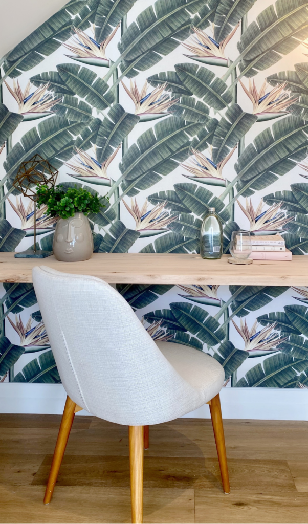little office nook with a playful palm themed tropical wallpaper