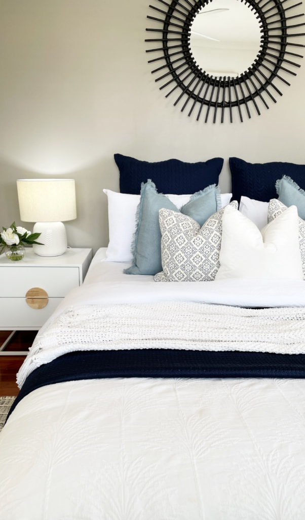blue coverlet and white throw over a beautiful blue bed