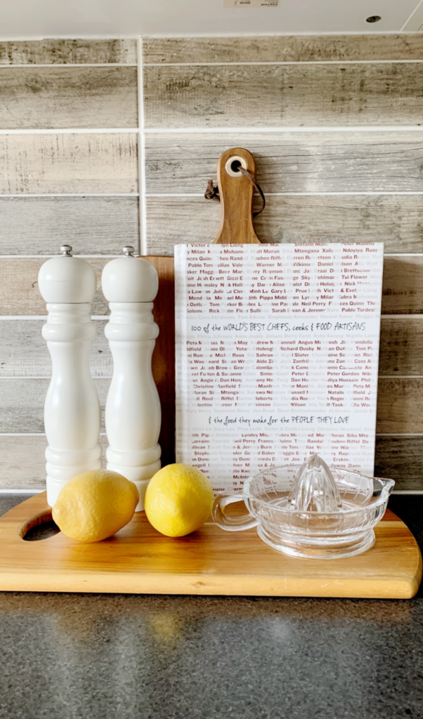 kitchen bench decoration, cutting boards with a cook book, salt and pepper shakers and lemons
