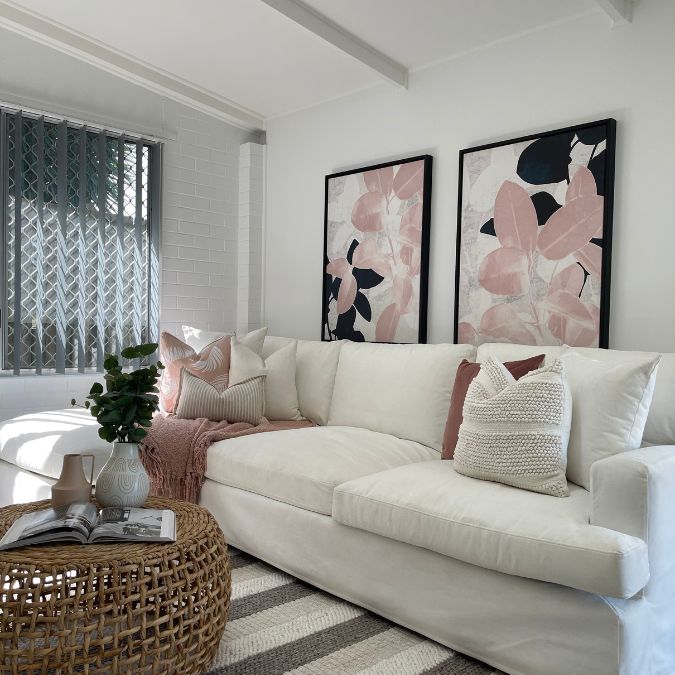 Pink in property styling - a modern living room with pink accessories.