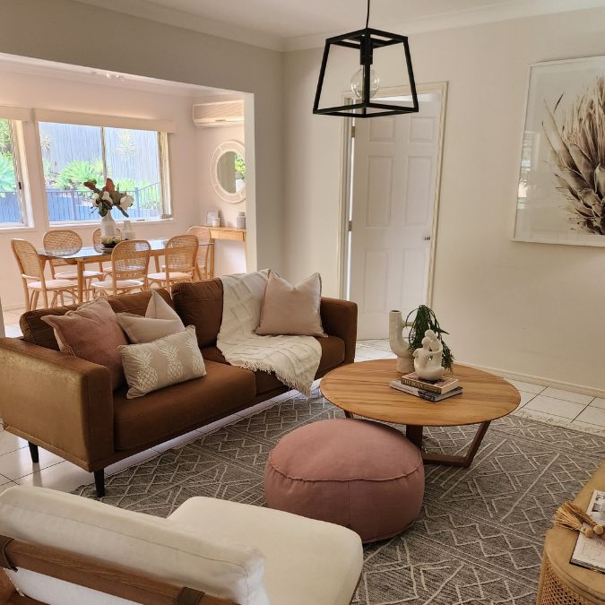 Pink in property styling - a living room with pink and neutral accents.